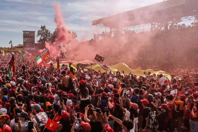 Ferrari fans with flags and red flares fill the circuit at Monza for the post-race podium celebrations