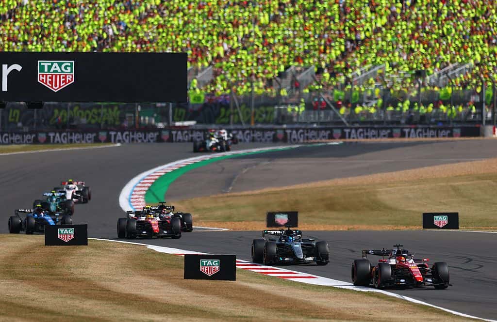 F1 cars stream through Silverstone's fast corners in front of packed grandstands
